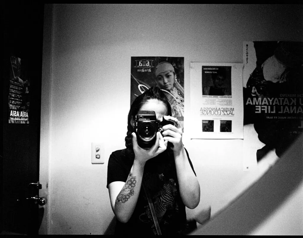 Self-portrait in a mirror, holding a medium-format camera